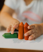 A small child holding Medenka's chunky beeswax crayons for little kids. 