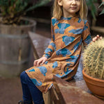  organic long sleeved dress in caramel brown with savannah and elephant repeat print. Worn by child