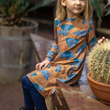  organic long sleeved dress in caramel brown with savannah and elephant repeat print. Worn by child