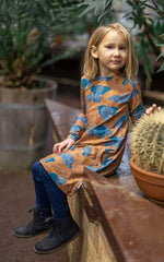  organic long sleeved dress in caramel brown with savannah and elephant repeat print. Worn by child