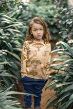  giraffes and tree names repeat print. Worn by child with long hair