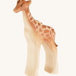 Bumbu wooden standing female giraffe on a cream background