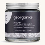  A jar of the charcoal Georganics toothpaste powder on a cream background