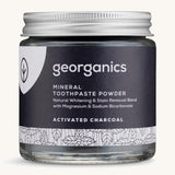  A jar of the charcoal Georganics toothpaste powder on a cream background