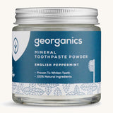  A jar of the peppermint Georganics toothpaste powder on a cream background