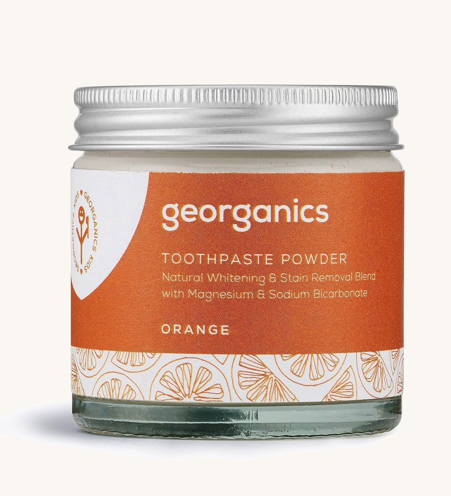  A jar of the orange Georganics toothpaste powder on a cream background
