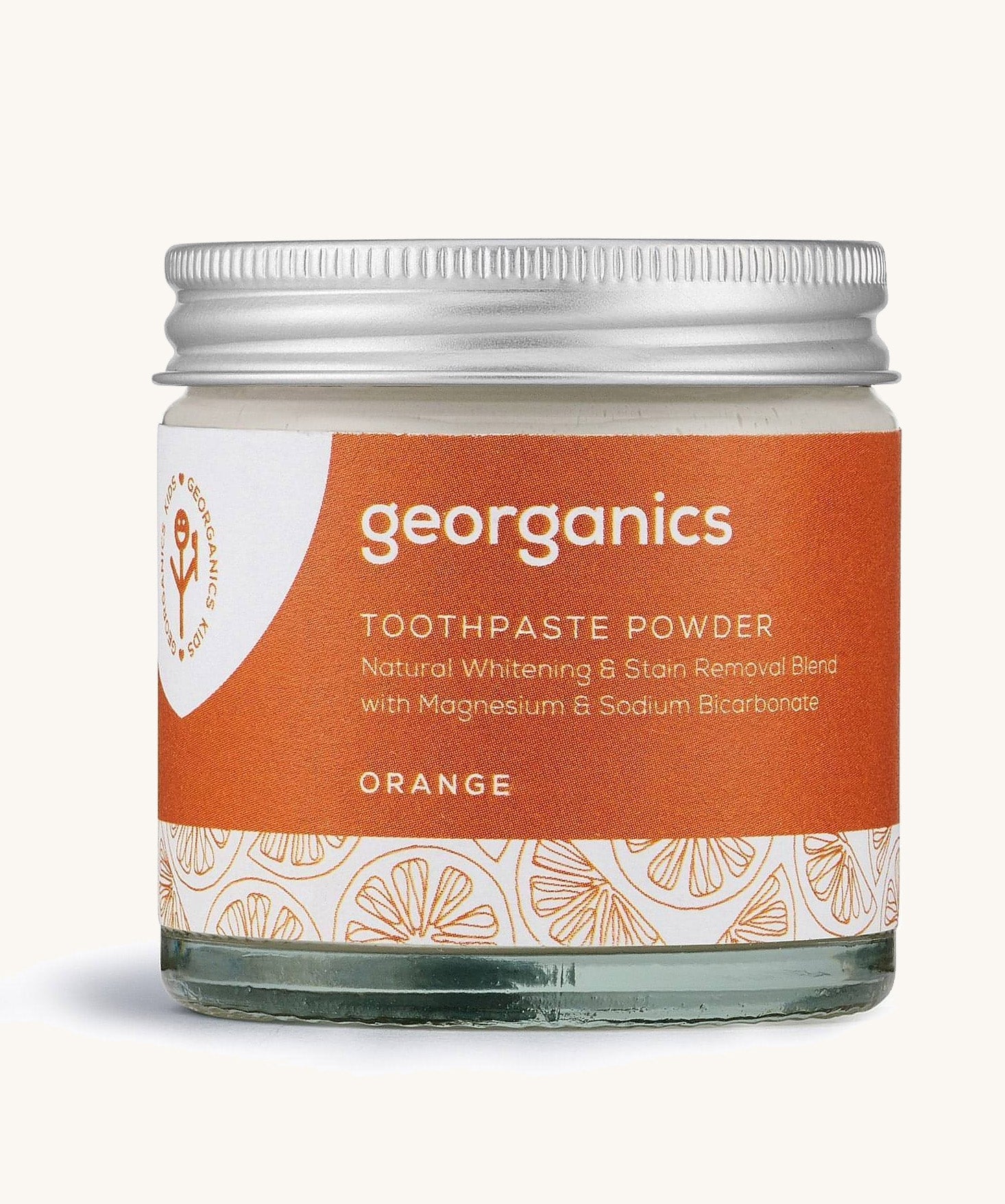  A jar of the orange Georganics toothpaste powder on a cream background
