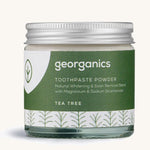  A jar of the tea tree  Georganics toothpaste powder on a cream background