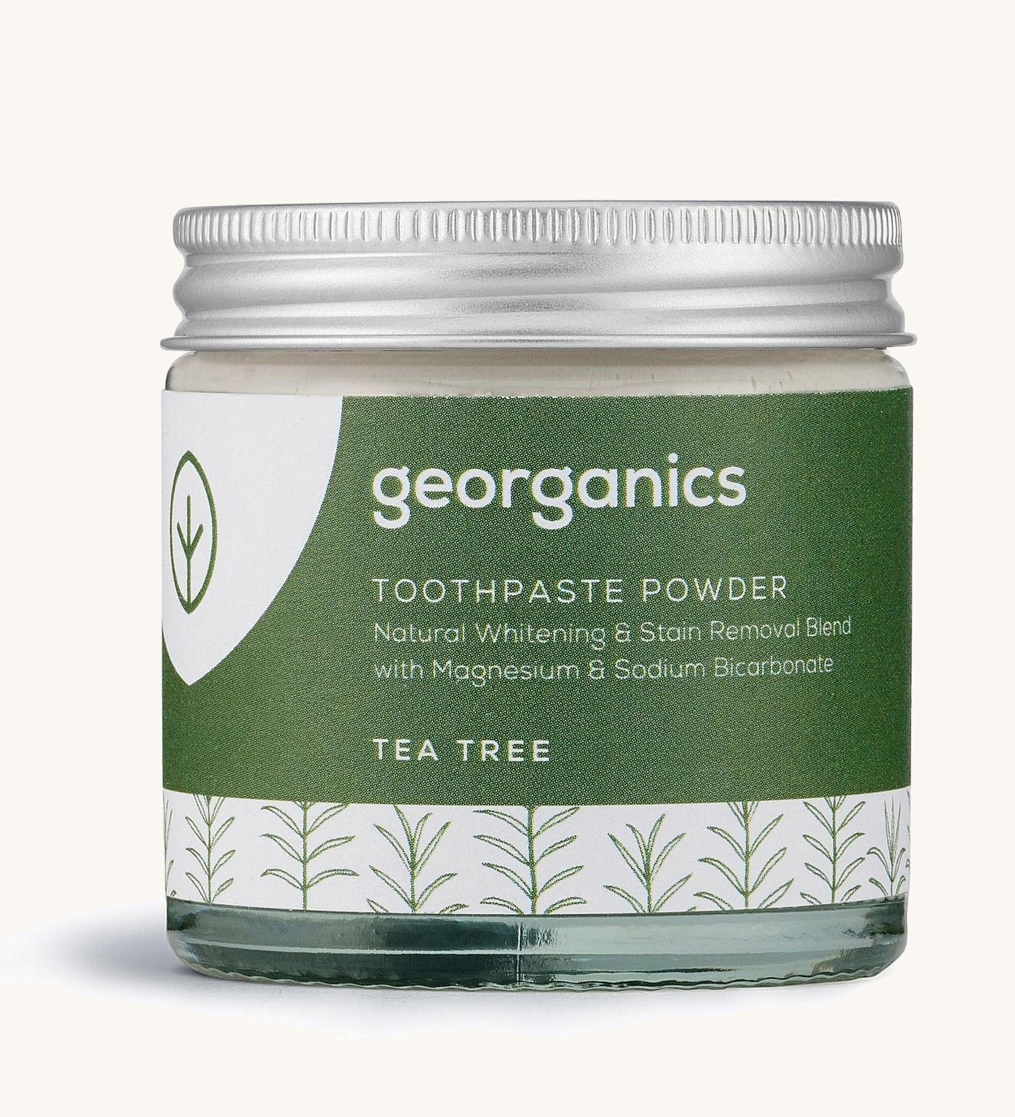  A jar of the tea tree  Georganics toothpaste powder on a cream background