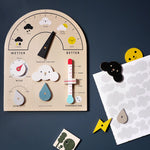 Plastic free wooden weather station toy on a dark grey background
