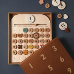 Moon Picnic wooden calendar set in its box on a dark grey background