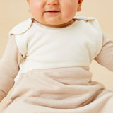  A baby inside the oatmeal sriped MORI sleeping bag showing the stripe detail on organic cotton fabric and popper fastener on the shoulder for easy fitting 
