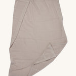 MORI cellular blanket in biscuit laid out showing the air hole detail on organic fabric. 