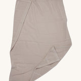 MORI cellular blanket in biscuit laid out showing the air hole detail on organic fabric. 