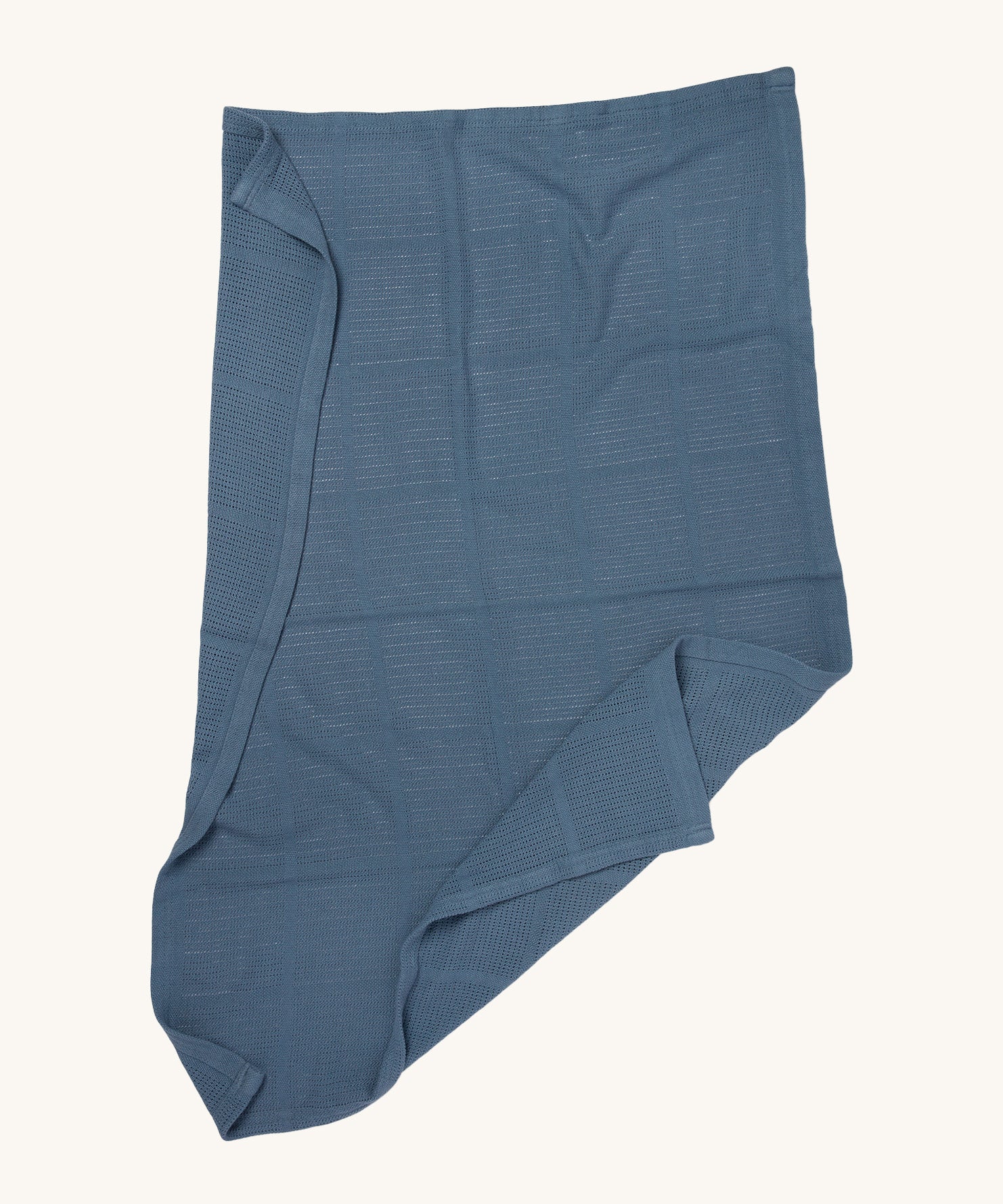 MORI cellular blanket in navy laid out showing the air hole detail on organic fabric. 
