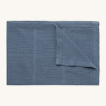 MORI cellular blanket in navy. A 100% organic fabric baby blanket in a dark blue colour with air hole to keep cool and warm on colder days. 