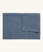 MORI cellular blanket in navy. A 100% organic fabric baby blanket in a dark blue colour with air hole to keep cool and warm on colder days. 