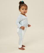 A toddler wearing the Mori organic cotton and bamboo kimono bodysuit in a blue stripe design.