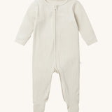 Mori two way zipped sleepsuit in ecru colour. A ribbed style all in one outfit made from bamboo and organic cotton. Features a two-way zip and concealed for safety