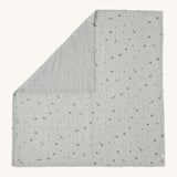 MORI muslin square in grey laid out flat showing the cute little prints of clouds and creatures in dark grey on organic cotton fabric