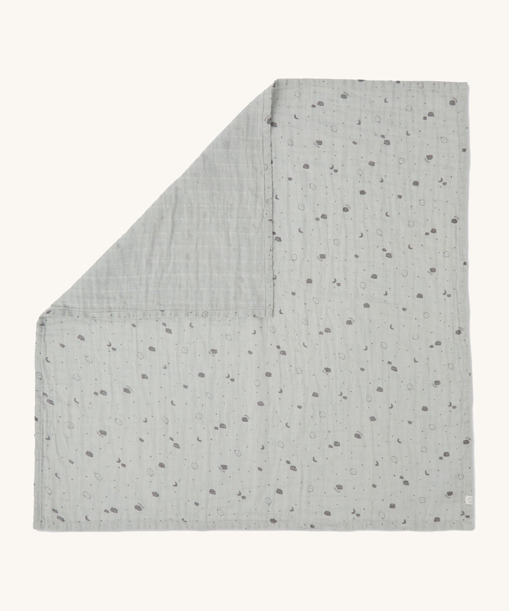 MORI muslin square in grey laid out flat showing the cute little prints of clouds and creatures in dark grey on organic cotton fabric