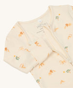 A close up of the MORI lion 2 way zip sleepsuit showing the zip slightly opened and lion print detail