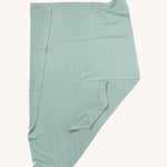 MORI cellular blanket in mint green laid out showing the air hole detail on organic fabric. 