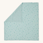 MORI muslin square in mint laid out flat showing the cute little prints of clouds and creatures in dark green on light green organic cotton fabric