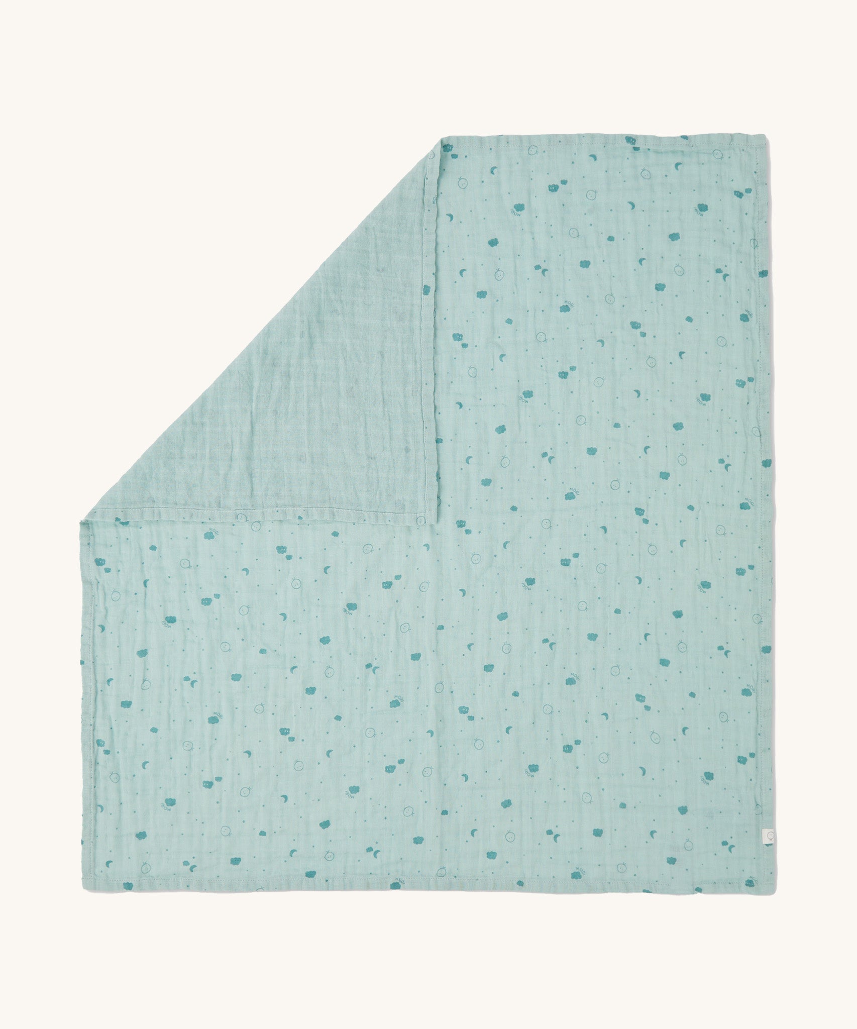 MORI muslin square in mint laid out flat showing the cute little prints of clouds and creatures in dark green on light green organic cotton fabric