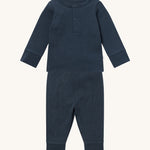MORI pyjamas in navy. A ribbed style pyjama set made from bamboo and organic cotton. Features a popper fastener top for easy fitting and elasticated cuffs on the arms and legs for a comfortable fit