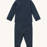 MORI pyjamas in navy. A ribbed style pyjama set made from bamboo and organic cotton. Features a popper fastener top for easy fitting and elasticated cuffs on the arms and legs for a comfortable fit