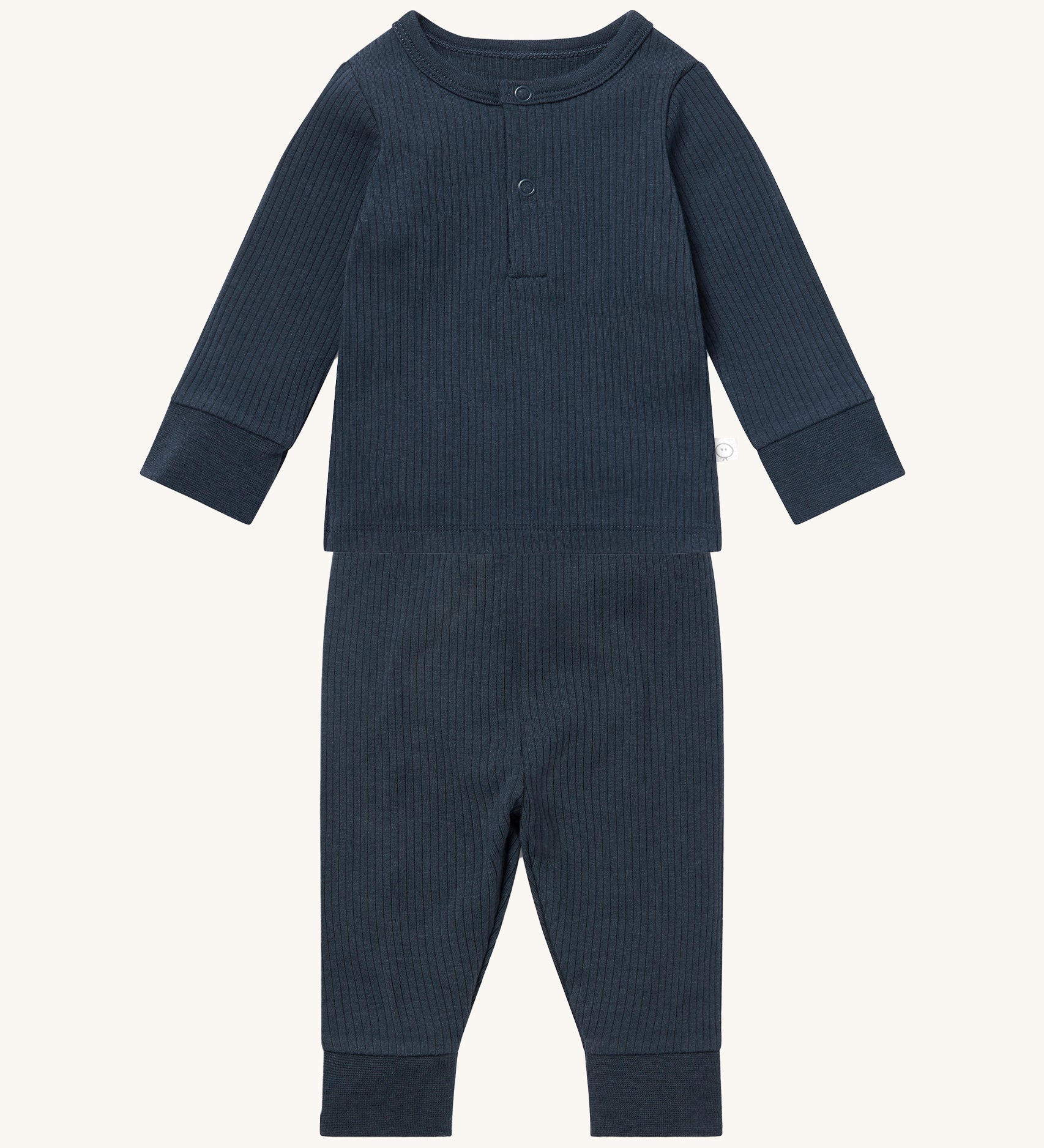 MORI pyjamas in navy. A ribbed style pyjama set made from bamboo and organic cotton. Features a popper fastener top for easy fitting and elasticated cuffs on the arms and legs for a comfortable fit