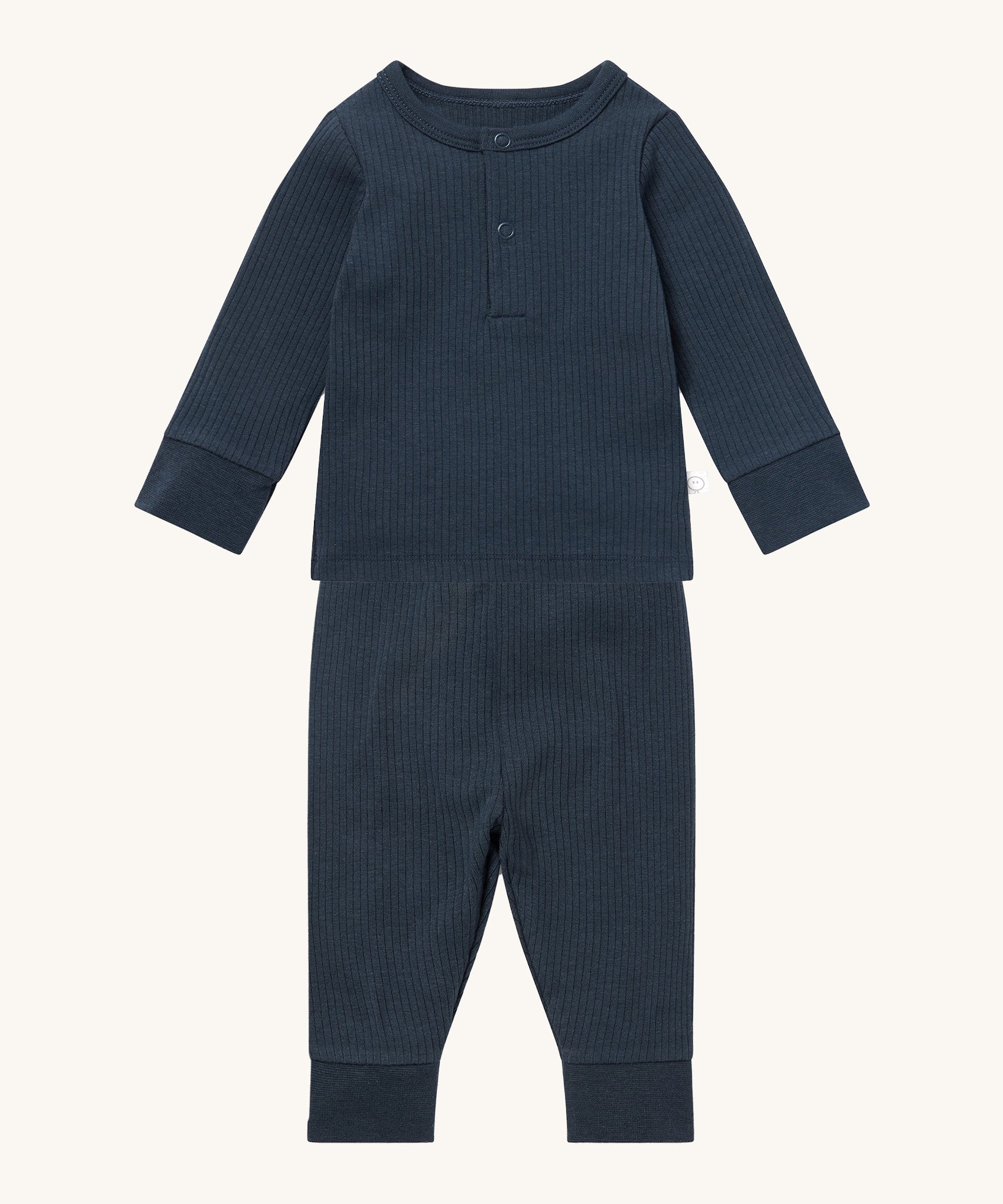 MORI pyjamas in navy. A ribbed style pyjama set made from bamboo and organic cotton. Features a popper fastener top for easy fitting and elasticated cuffs on the arms and legs for a comfortable fit