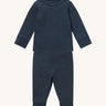 MORI pyjamas in navy. A ribbed style pyjama set made from bamboo and organic cotton. Features a popper fastener top for easy fitting and elasticated cuffs on the arms and legs for a comfortable fit