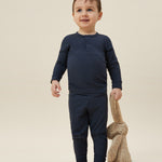 A toddler wearing the MORI ribbed style pyjama set in navy colour