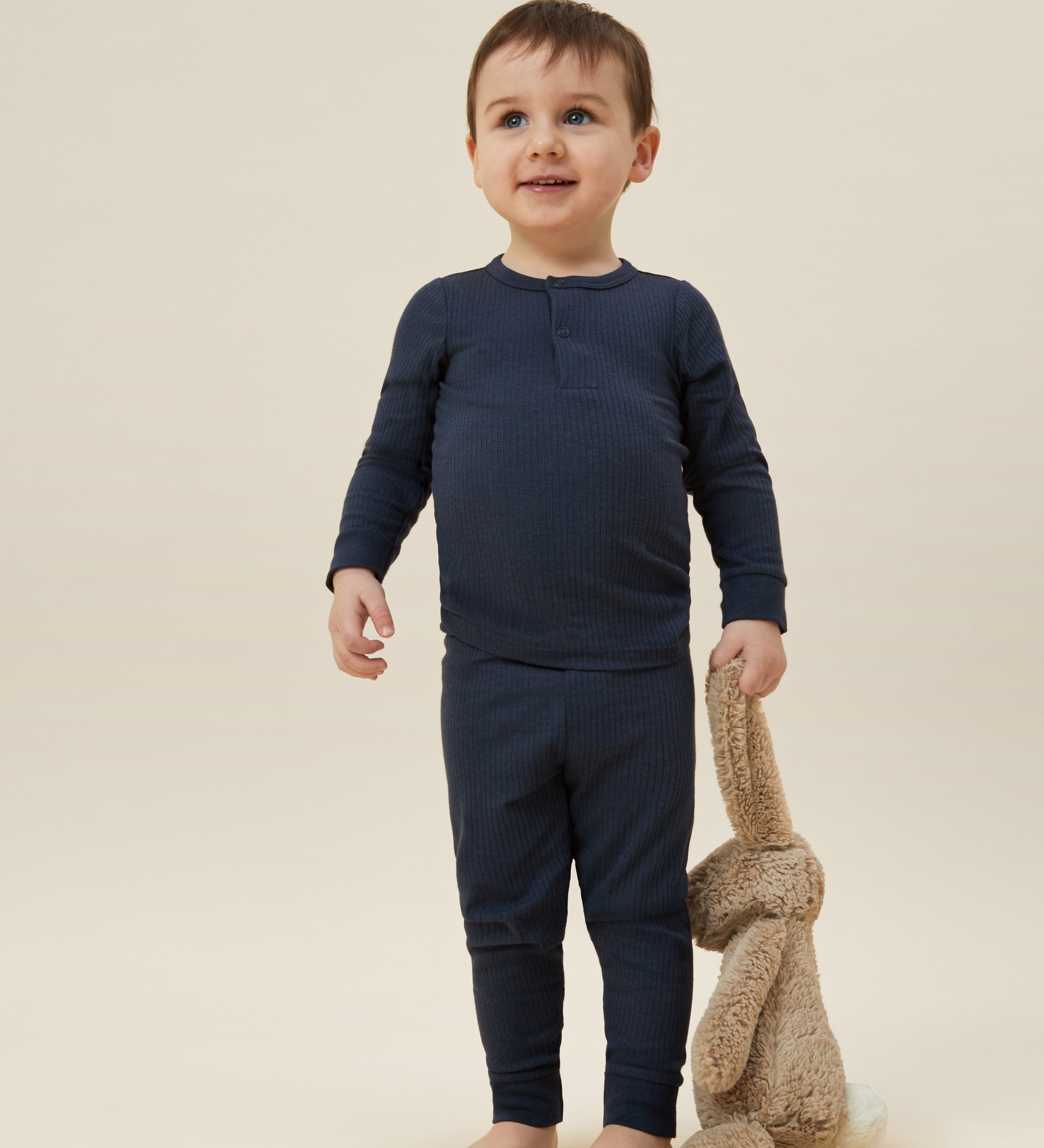 A toddler wearing the MORI ribbed style pyjama set in navy colour