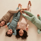 Four children wearing colour coordinating Mori ribbed outfits, including the comfy joggers