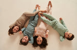 Four children wearing colour coordinating Mori ribbed outfits, including the comfy joggers