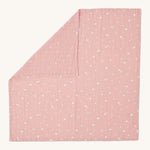 MORI muslin square in pink laid out flat showing the cute little prints of clouds and creatures in white on organic cotton fabric