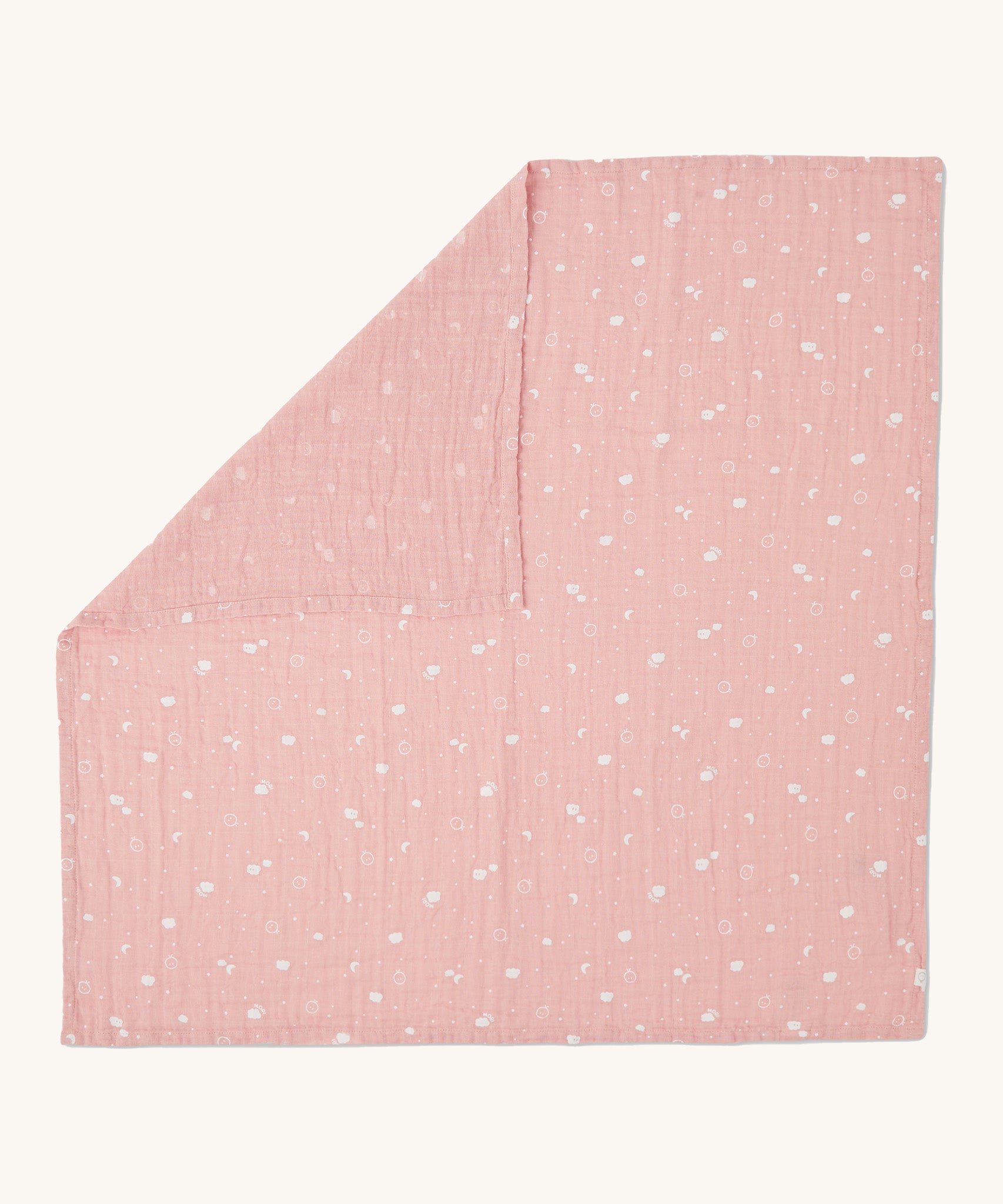 MORI muslin square in pink laid out flat showing the cute little prints of clouds and creatures in white on organic cotton fabric