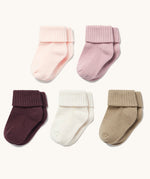five pairs of baby socks in different shades of pink and cream