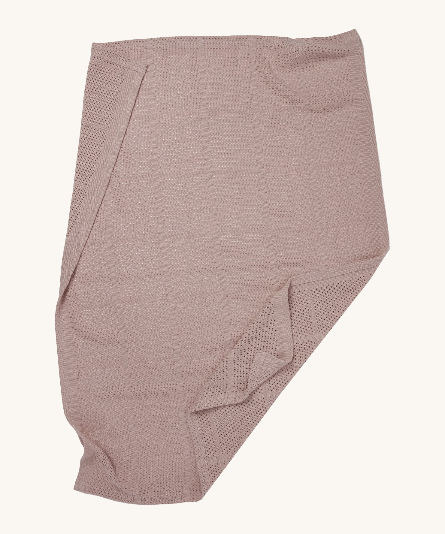 MORI cellular blanket in rose laid out showing the air hole detail on organic fabric. 
