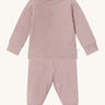 MORI pyjamas in rose. A light pink ribbed style pyjama set made from bamboo and organic cotton. Features a popper fastener top for easy fitting and elasticated cuffs on the arms and legs for a comfortable fit