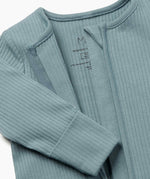 A close up of the concealed zip detail on the MORI two way sleepsuit in sky blue on organic fabric