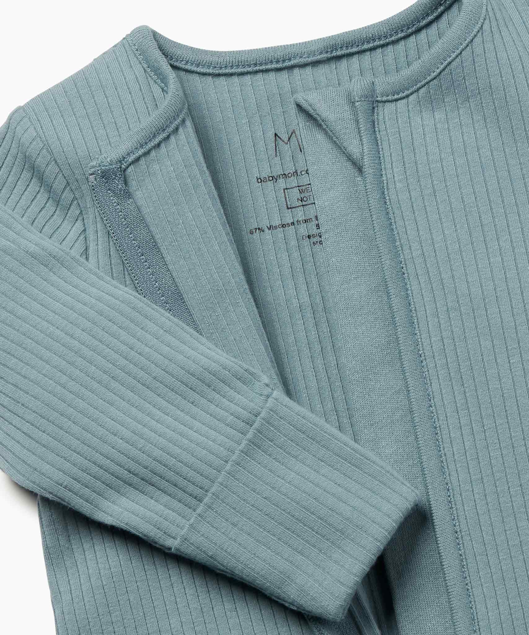 A close up of the concealed zip detail on the MORI two way sleepsuit in sky blue on organic fabric