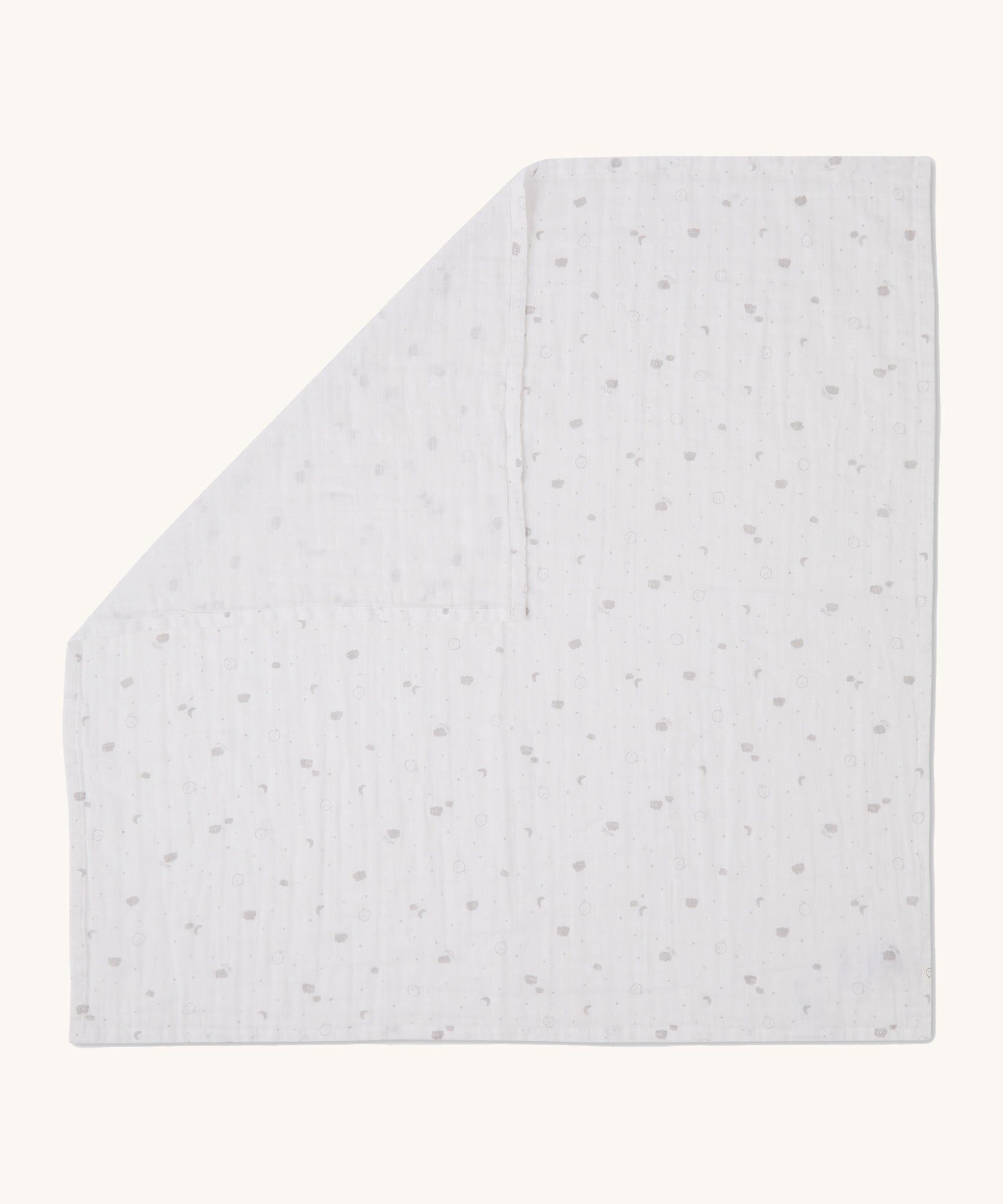 MORI muslin square in white laid out flat showing the cute little prints of clouds and creatures in dark grey on organic cotton fabric