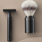 Muhle Rocca jet black stainless steel safety razor next to a maching shaving brush with silvertip synthetic fibres