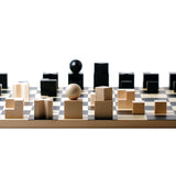 Naef premium wooden chess pieces on the Naef Bauhaus chess board on a white background