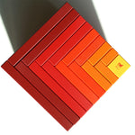 Naef Cella Cubes stacked corner to corner on top of each other on a white background.
