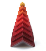 Naef's Cella cube toy stacked in a pyramid shape on a white background.